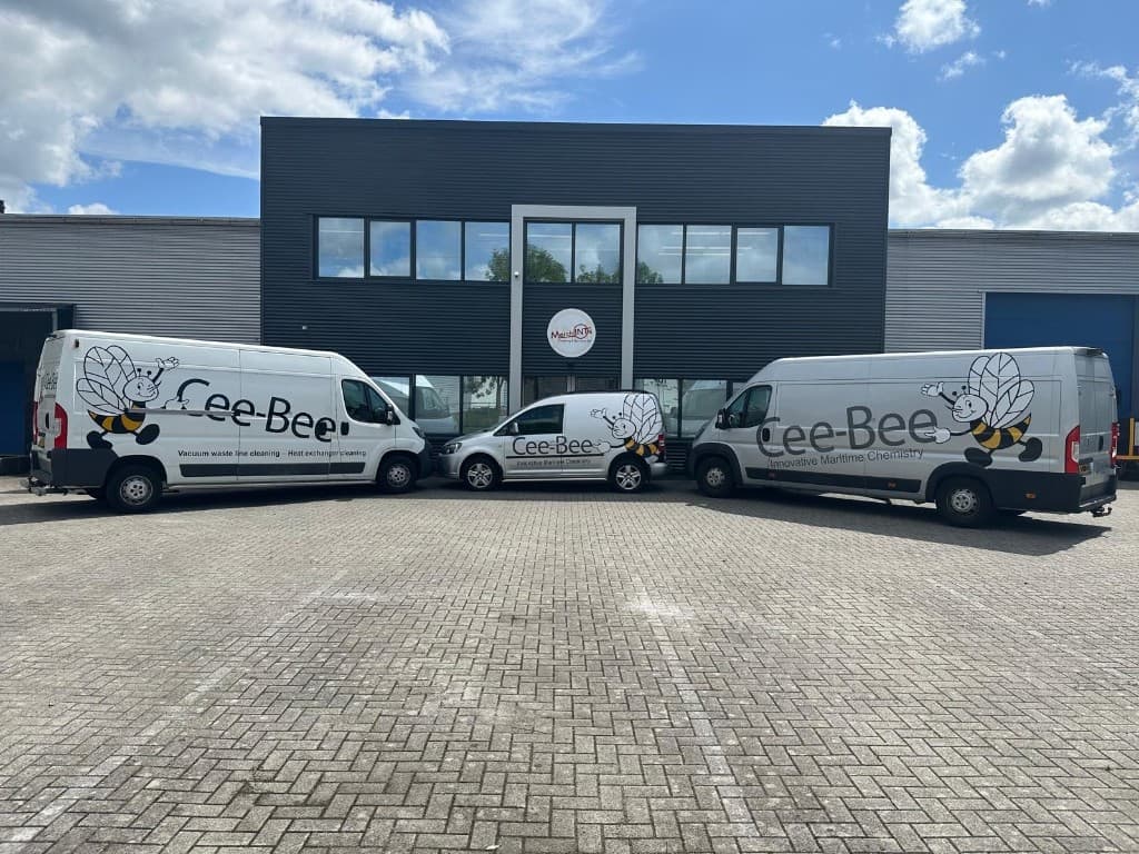 MerchINTs vehicles in front of company building