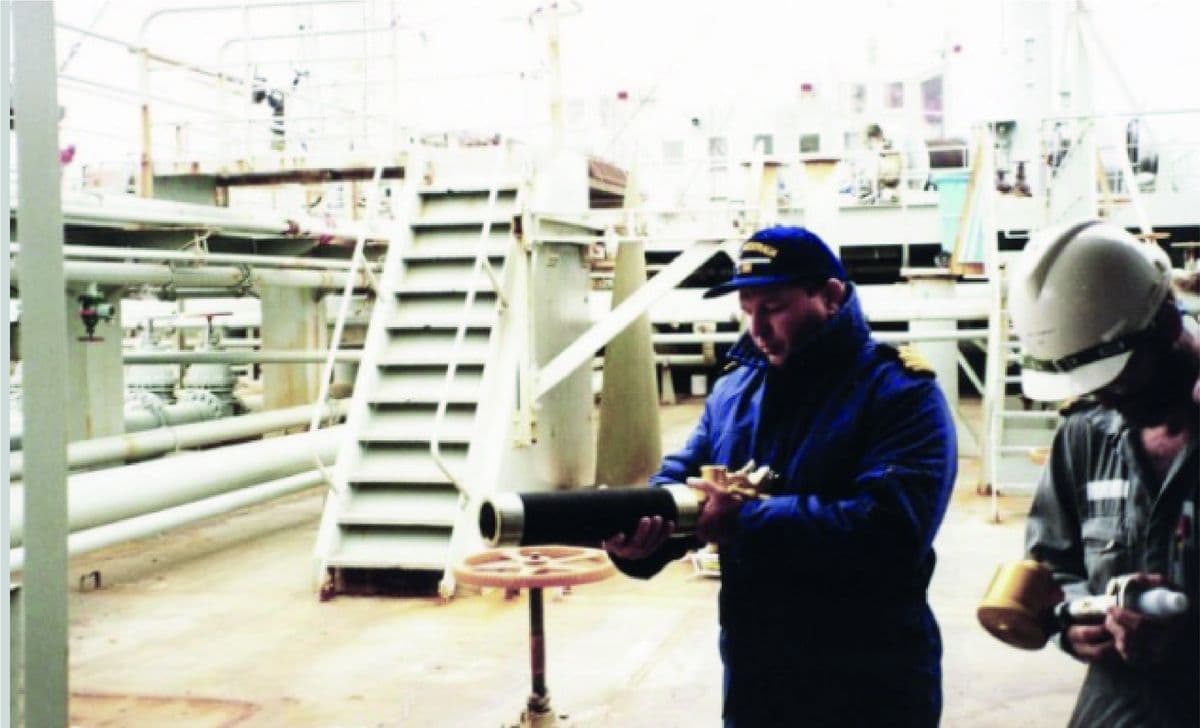 Engineer operating a pneumatic launcher on deck